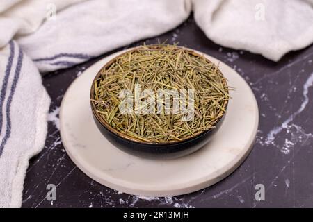 Dried herbs rosemary leaf. Dry seasoning rosemary on dark background. Spices and herbs for cooking, provence herbs Stock Photo