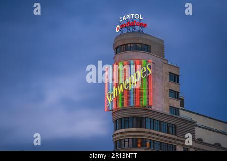 Schweppes neon sign of Edificio Capitol (or Carrion) Building at Gran Via Street - Madrid, Spain Stock Photo