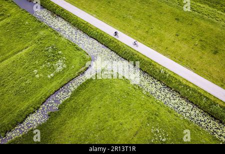 HOEKSCHE WAARD - 11/05/2023,  Drone photo of cyclists along a ditch in the Hoeksche Waard. The Netherlands is in danger of being further locked down due to poor water quality. ANP JEFFREY GROENEWEG netherlands out - belgium out Stock Photo