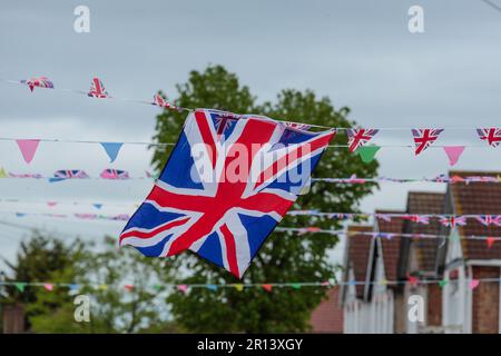 Wembley, Middx, UK. Coronation Street Party. A residential road in Wembley UK decorated with colourful Union Jack bunting and flags in preparation for Stock Photo