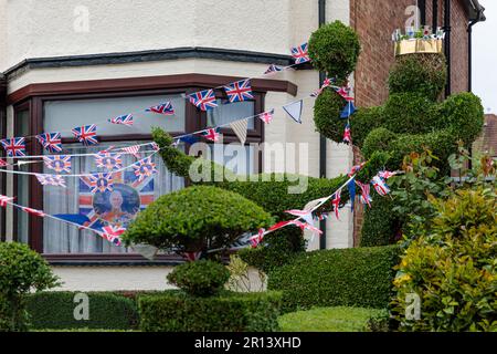 Wembley, Middx, UK. Coronation Street Party. A residential house in Wembley UK decorated with colourful Union Jack bunting and flags and a crowned top Stock Photo