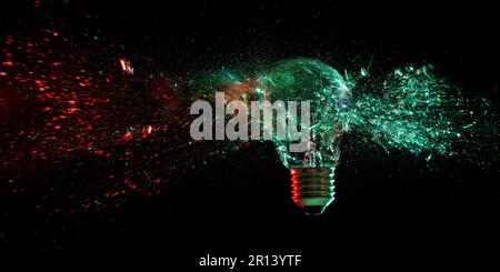light bulb shattering on black background Stock Photo