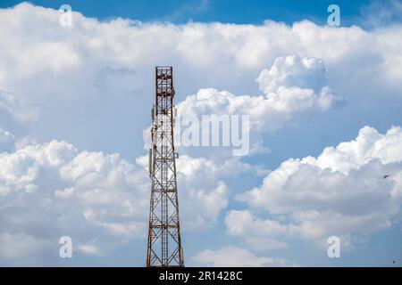 Telecommunication tower with blue sky and white cloud. Radio or satellite pole. Mobile 4g,5g network technology. Stock Photo