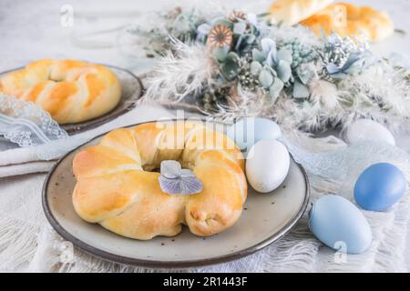 Homemade easter buns on a table decorated for easter brunch or breakfast Stock Photo