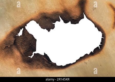 A hole in the scorched old yellow, crumpled paper. Baking paper after fire. Fire Stock Photo