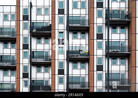 Leuven, Flemish Brabant Region, Belgium - April 1, 2023 - Facade with windows and balconies of a social housing apartment block Stock Photo