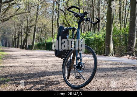 Averbode, Laakdal, Belgium -  April 21, 2023 - Trekking bike standing in the woods Stock Photo