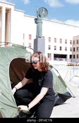 Unity in Protest: Students of Sapienza University in Rome share a moment of camaraderie in their encampment during a protest against rising rental. Stock Photo