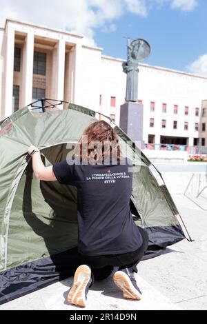 Unity in Protest: Students of Sapienza University in Rome share a moment of camaraderie in their encampment during a protest against rising rental. Stock Photo