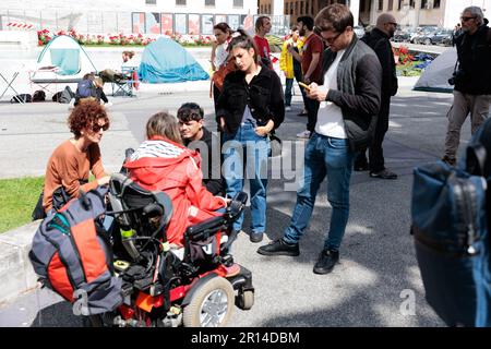 Unity in Protest: Students of Sapienza University in Rome share a moment of camaraderie in their encampment during a protest against rising rental. Stock Photo