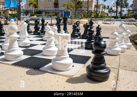 Life Size Chess Pieces On A Board Outside At A Hotel Pool Side Stock Photo  - Download Image Now - iStock