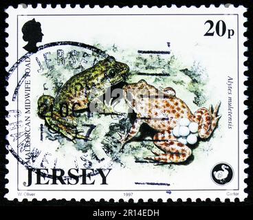 MOSCOW, RUSSIA - APRIL 08, 2023: Postage stamp printed in Jersey shows Mallorcan Midwife Toad (Alytes muletensis), Wildlife Preservation Trust (6th se Stock Photo