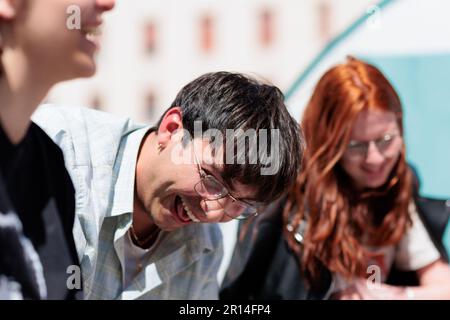 Unity in Protest: Students of Sapienza University in Rome share a moment of camaraderie in their encampment during a protest against rising rental. Stock Photo