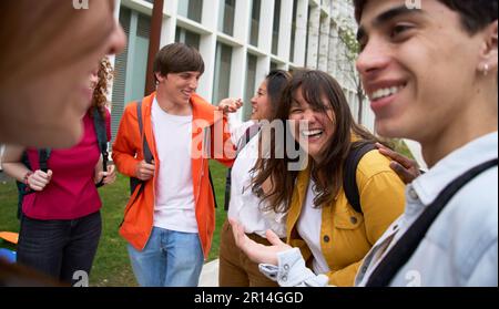 Group of multiracial young students having fun walking together on college campus. Scholarship. Stock Photo