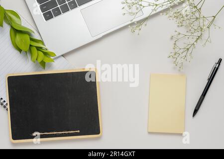 Copyspace of minimal workplace with office supplies on wooden table and  white wall background. by Sirinarth Mekvorawuth. Photo stock - StudioNow