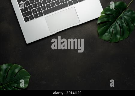 Top view of laptop on black background. Flat lay, top view office table desk. Stock Photo