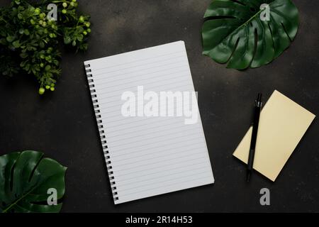 Top view of blank notebook with pencil on black background. Stock Photo