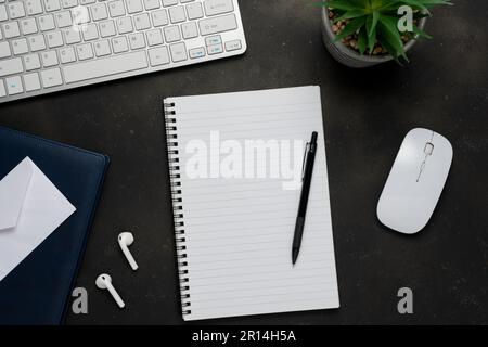 Modern desk with keyboard, earphones, office supplies. Top view with copy space. Stock Photo