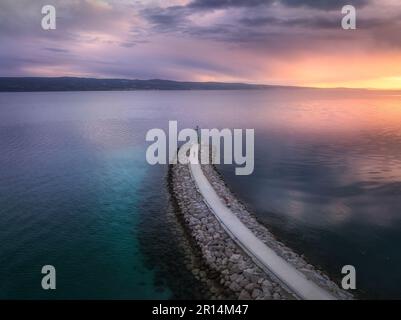 Aerial view of lighthouse on the pier at sunset in summer Stock Photo
