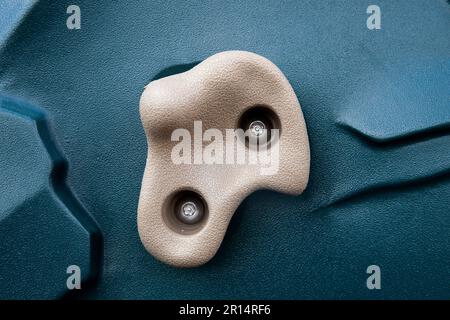 close up of tan and green playground rock climbing handle Stock Photo