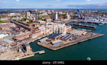 Aerial view of Portsmouth Historic Dockyard and the Royal Navy's ancient HMS Warrior warship on the English Channel coast in the south of England, Uni Stock Photo