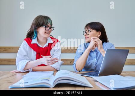 Young teenage female studying languages with teacher in classroom Stock Photo