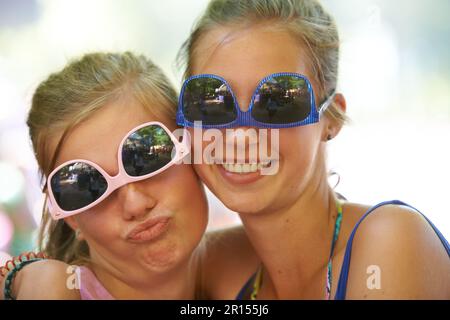They love being silly together. Cropped portrait of a group of girlfriends at an outdoor festival. Stock Photo