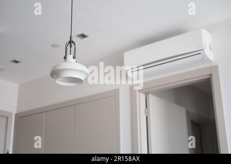 Modern air conditioner hanging on white wall Stock Photo - Alamy