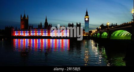 Projections on Big Ben in London to celebrate the Coronation of King Charles III - Light show on Elizabeth Tower and the Houses of Parliament in Westm Stock Photo