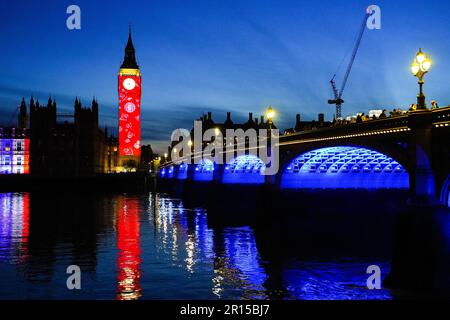 Projections on Big Ben in London to celebrate the Coronation of King Charles III - Light show on Elizabeth Tower and the Houses of Parliament in Westm Stock Photo