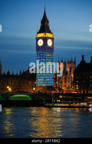 Projections on Big Ben in London to celebrate the Coronation of King Charles III - Light show on Elizabeth Tower and the Houses of Parliament in Westm Stock Photo