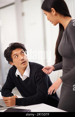 Listening to a colleagues advice. two business colleagues discussing work in the office. Stock Photo