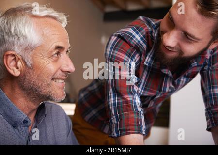 Keeping it in the family. Head and shoulder shot of two men standing together in theor workshop. Stock Photo