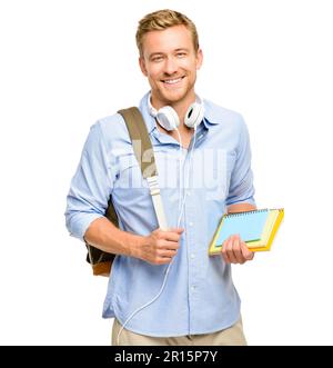 Focused on my personal growth. a handsome young student standing alone in the studio and carrying his textbooks. Stock Photo