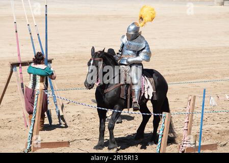 Folsom, CA, September 24, 2022. Unidentified male at the Folsom Renaissance Faire dressed as a knight ridding a black horse in the arena Stock Photo