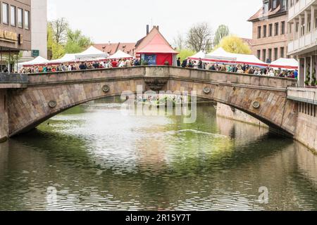 NUERNBERG, GERMANY, APRIL 6: People at a market on Fleisch Bridge in Nuernberg, Germany on April 6, 2014. The renaissance bridge from the 16th Stock Photo