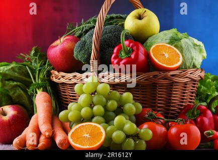 Fresh organic fruits and vegetables in wicker basket Stock Photo