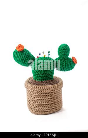 pincushion in the shape of a cactus in a pot, crocheted, on a white background Stock Photo