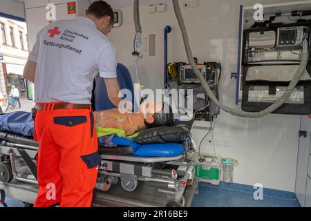 DRK staff in the ambulance Ambulance with dummy as demonstration Stock Photo