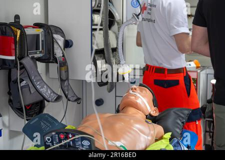 DRK staff in the ambulance Ambulance with dummy as demonstration Stock Photo