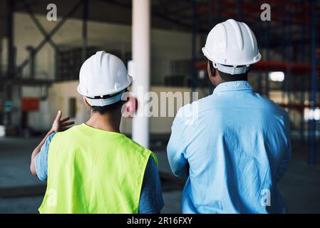 What the client wants, the client gets. two builders inspecting a construction site. Stock Photo