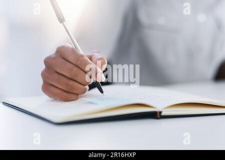 Hand, pen and writing in notebook or planning, working and notes in journal, book or record for study or research. Person, write and closeup on work Stock Photo