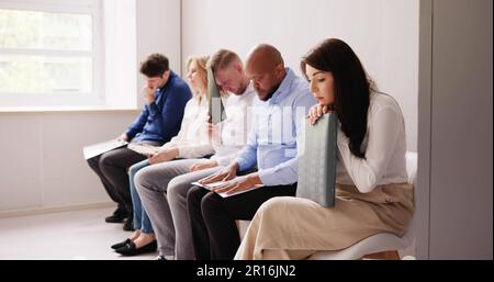 Business People Are Getting Bored While Sitting On Chair Waiting For Job Interview In Office Stock Photo