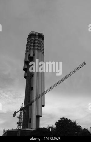 Workers dismantling a tall crane at Roi Et tower in Roi Et Thailand Stock Photo