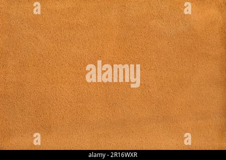 Orange suede leather texture background. Natural material pattern. Stock Photo