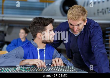 two flight engineers working in hangar Stock Photo