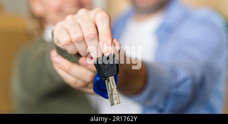 Couple showing keys to new apartment. real estate mortgage, loan concept. moving in new house Stock Photo