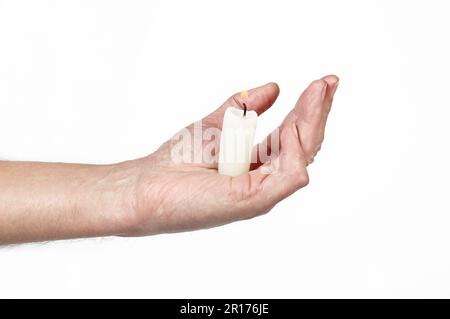 Men's hand holding a candle isolated white background. Man holding burning candle, closeup Stock Photo
