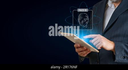 Man using tablet with face id scan and modern technology. Login using Face id and AI Stock Photo