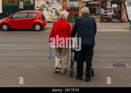 an old couple want to cross a street, man with walker Stock Photo